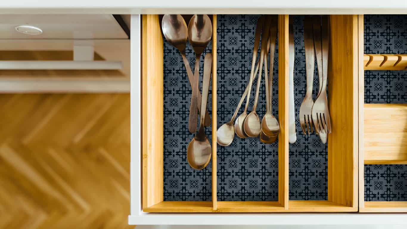 Utensil drawer with blue contact paper shelf liner